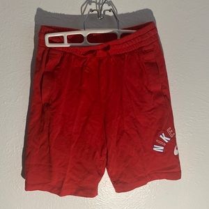 Long red Nike shorts